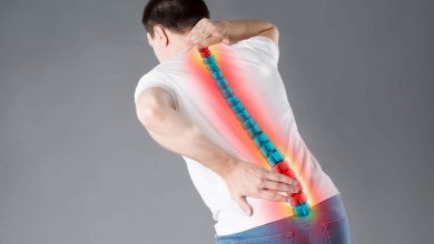 Uomo che tiene la mano sul collo mentre soffre di dolori cervicali.